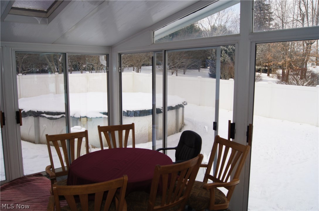 1774 Nichols Road Akron, OH 44312 - Photo 3 of 22 The surround floor to ceiling windows and skylights in the Sunroom off the living room provides lots of natural light, and a great view of the large private back yard.