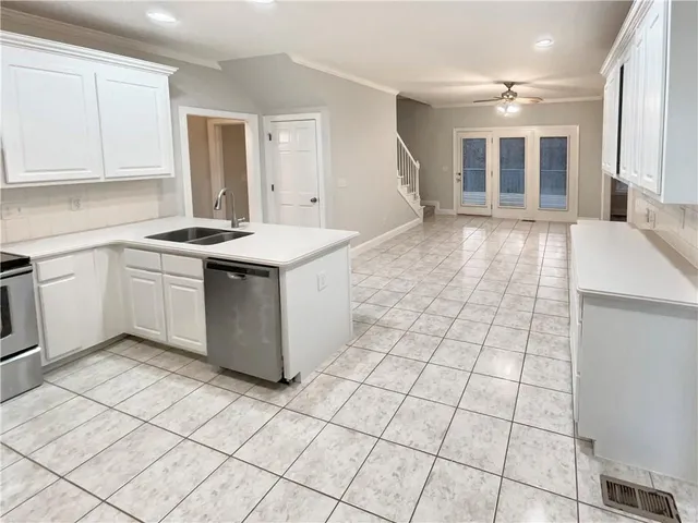 a kitchen with a sink and a stove top oven