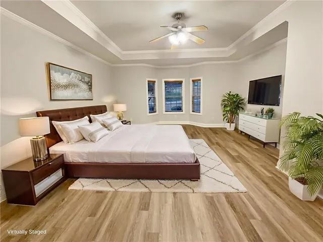 a spacious bedroom with a large bed and a flat screen tv