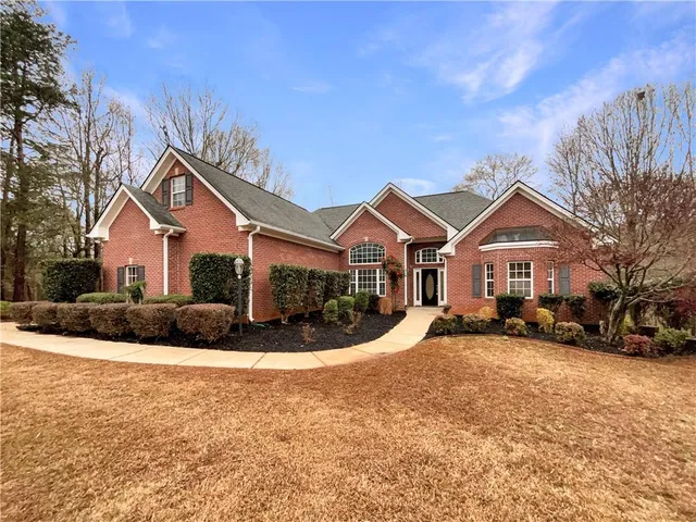 a front view of a house with a yard