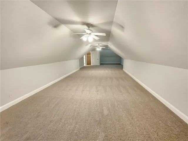 a view of a hallway with window and chandelier