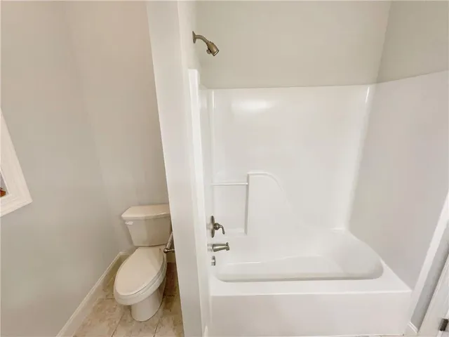 a bathroom with a bathtub and toilet