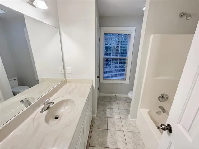 a bathroom with a tub sink and a mirror