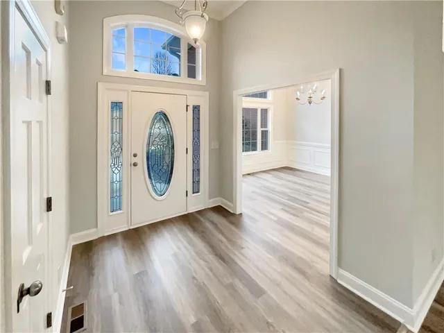 a view of a hallway with wooden floor and a large window