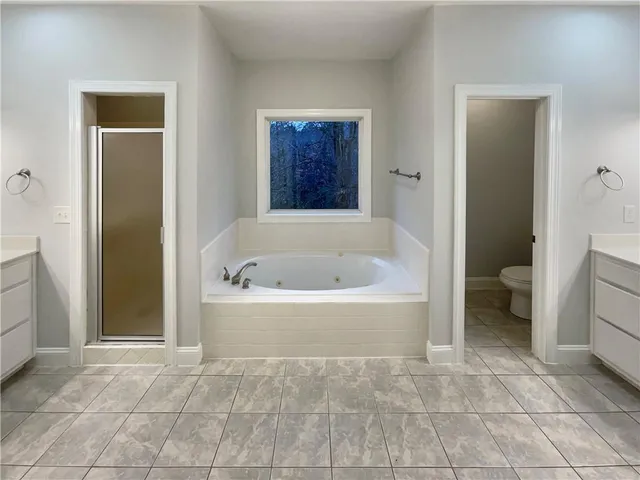 a white bath tub sitting next to a toilet