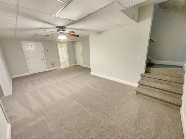 en view interior of a house with stairs and a ceiling fan