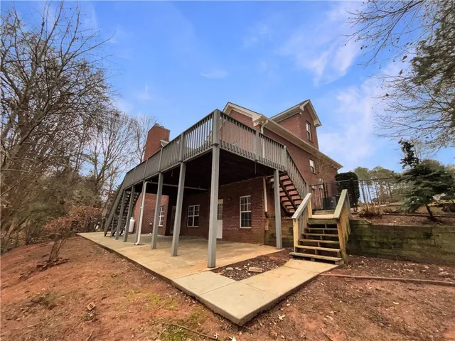 a view of a house with backyard porch and sitting area