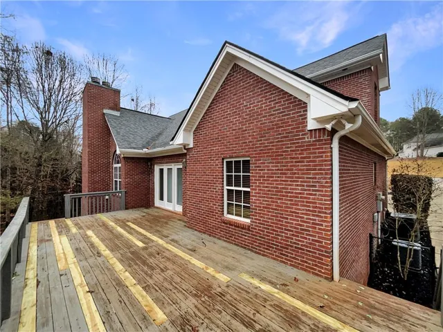 a view of a house with wooden fence