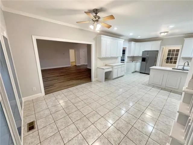 a view of kitchen with sink and window