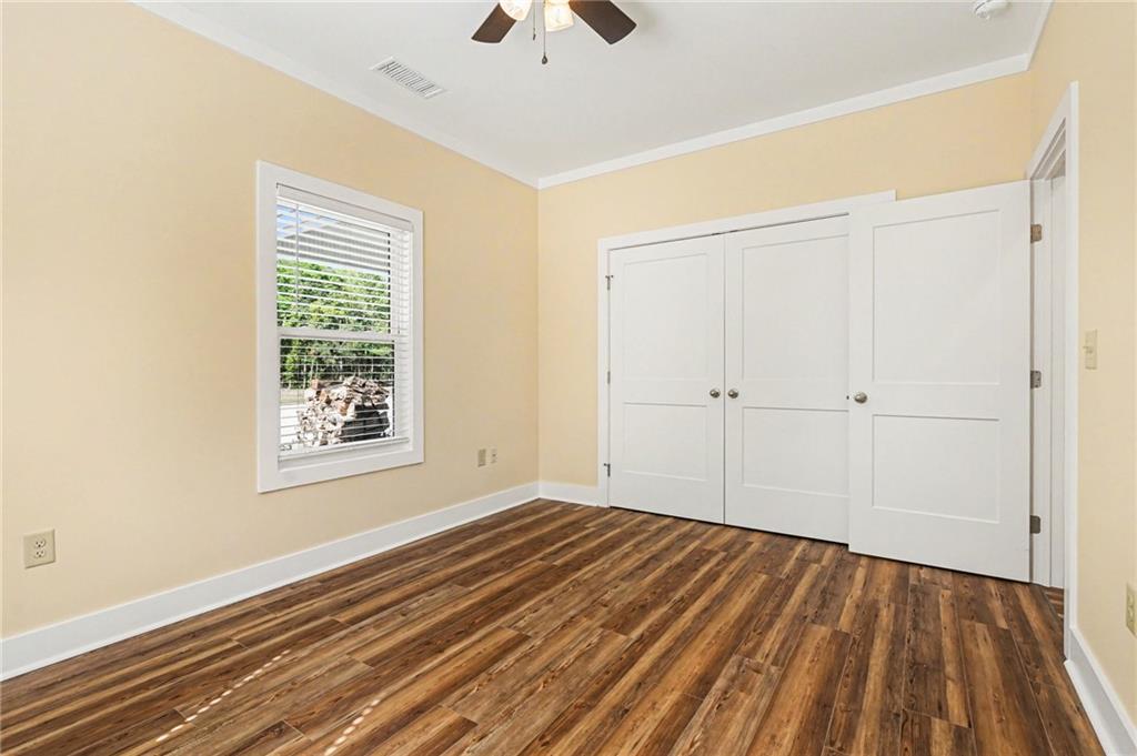 1596 Kirk-Langford Road Danielsville, GA 30633 - Photo 18 of 37 a view of an empty room with wooden floor and a window