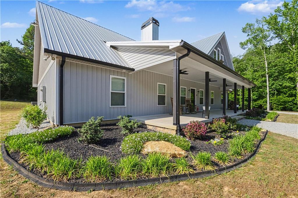 1596 Kirk-Langford Road Danielsville, GA 30633 - Photo 2 of 37 a view of a house with sitting area and garden