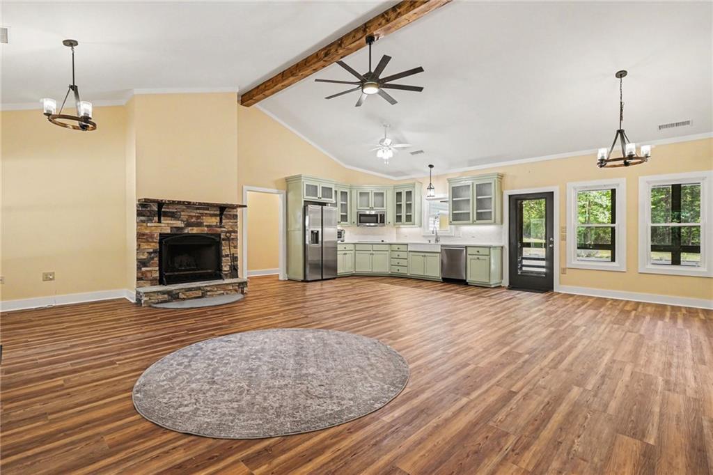 1596 Kirk-Langford Road Danielsville, GA 30633 - Photo 5 of 37 an empty room with wooden floor and windows