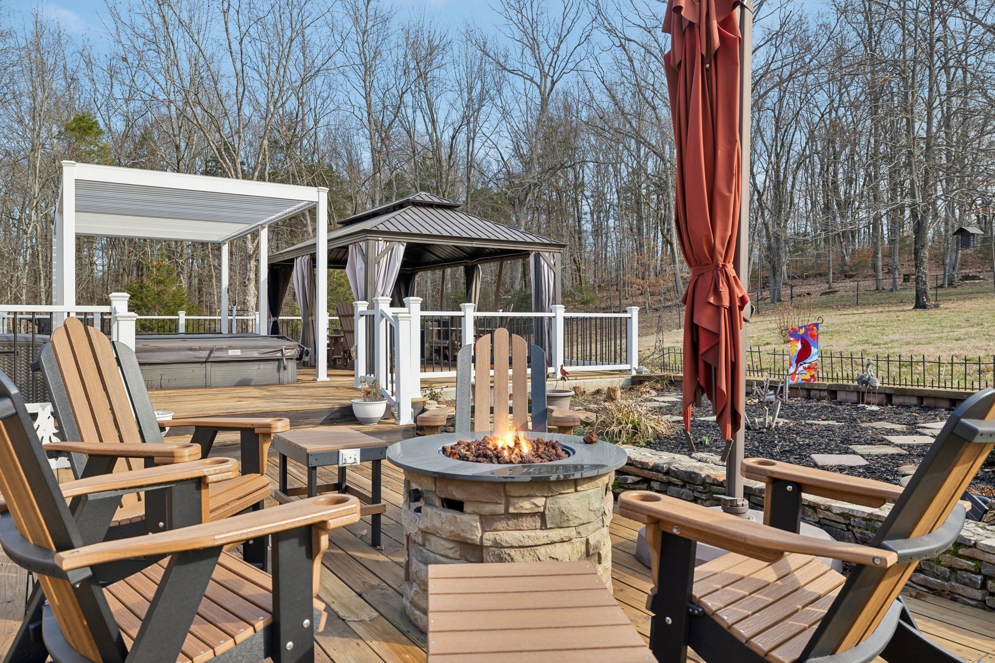 2079 Rock Springs Road Columbia, TN 38401 - Photo 49 of 83 a view of a patio with table and chairs under an umbrella with barbeque grill and wooden fence