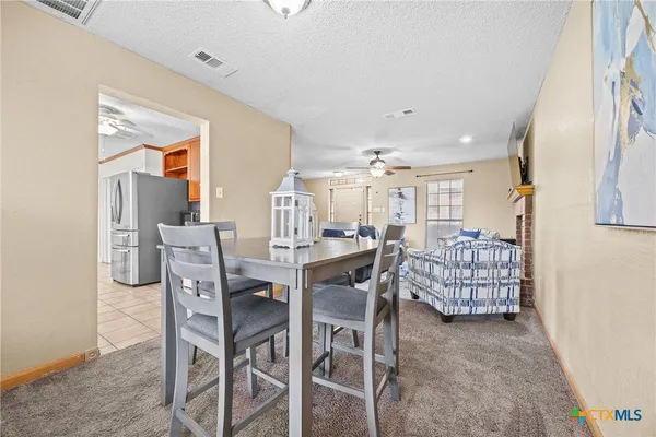 a dining room with furniture and window