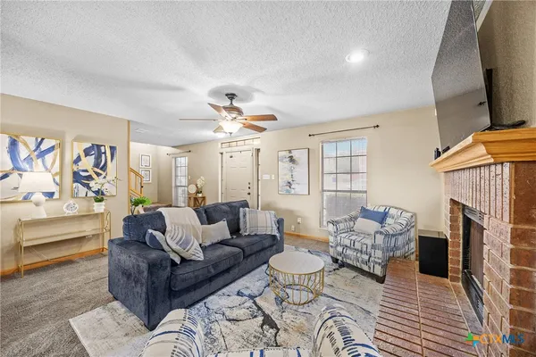 a living room with fireplace furniture and a flat screen tv