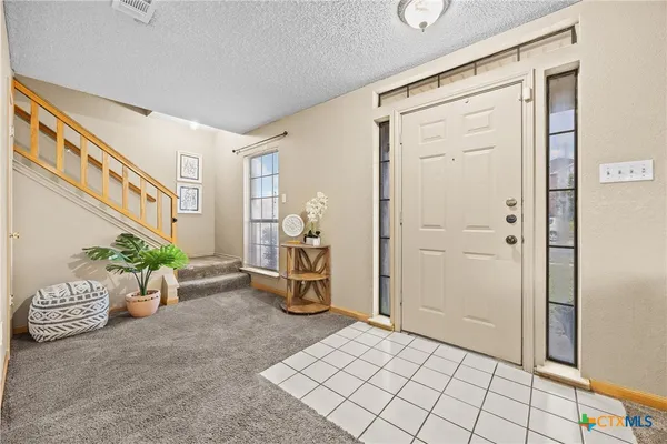 a view of a hallway and a livingroom with furniture