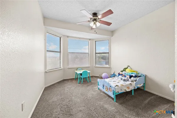 a bedroom with furniture and a window