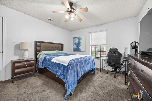 a bedroom with a bed and a chandelier