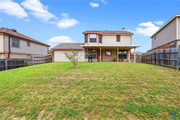 a view of a house with a yard and sitting area