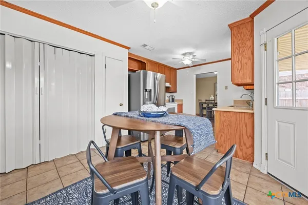 a view of a dining room with furniture and a window
