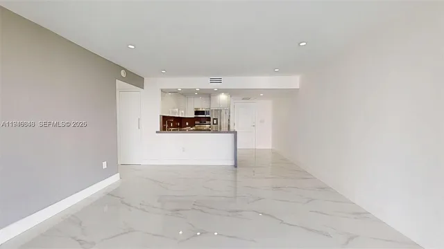 an empty room with cabinet and mirrors