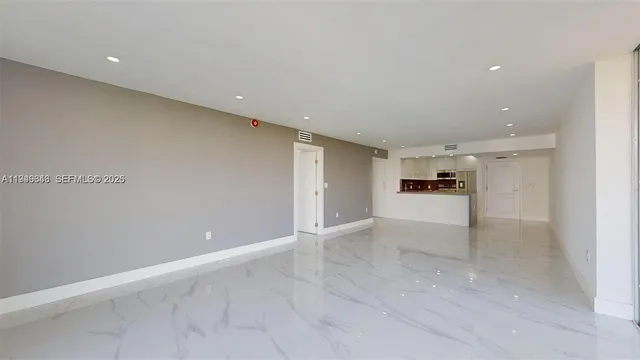 a view of an empty room with a floor to ceiling window and an empty room