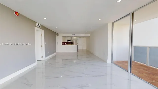 a view of an empty room with large windows