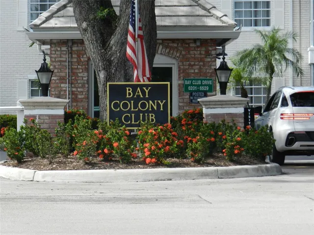 a sign that is sitting in front of flowers