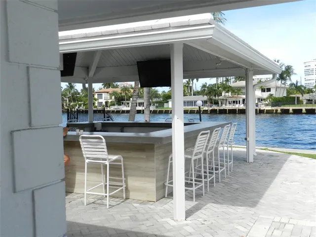 a view of a backyard with a fountain and large trees