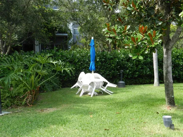 a view of a chairs and table on the wooden deck