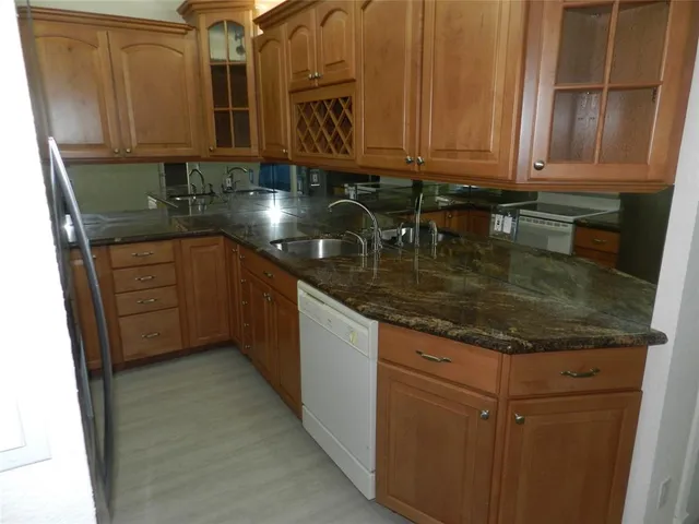 a kitchen with stainless steel appliances granite countertop a sink stove and cabinets