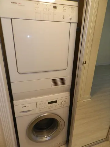 a bathroom with a granite countertop toilet and a sink
