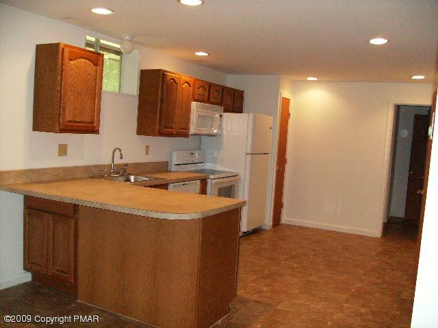 117 Decker Road Bushkill, PA 18324 - Photo 3 of 10 a kitchen with stainless steel appliances a refrigerator and a sink