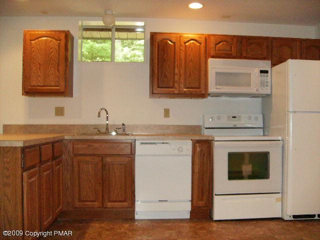 117 Decker Road Bushkill, PA 18324 - Photo 4 of 10 a kitchen with a sink and a refrigerator