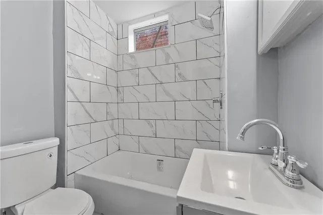 a bathroom with a toilet and a sink