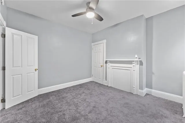 a view of empty room with ceiling fan