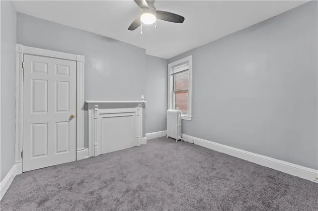 an empty room with a ceiling fan