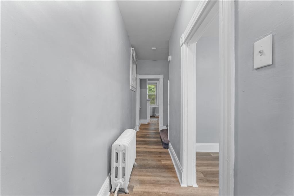147 Moultrie Street Pittsburgh, PA 15219 - Photo 4 of 30 a view of a hallway with wooden floor and staircase