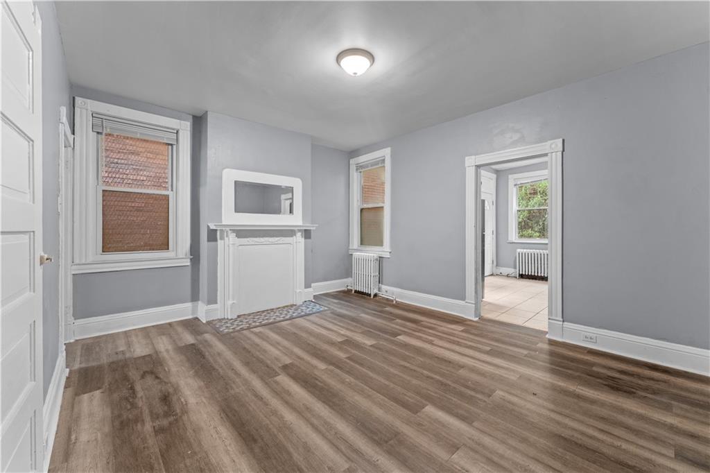 147 Moultrie Street Pittsburgh, PA 15219 - Photo 6 of 30 a view of an empty room with wooden floor and a window
