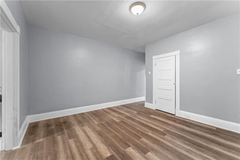 147 Moultrie Street Pittsburgh, PA 15219 - Photo 7 of 30 an empty room with wooden floor and windows