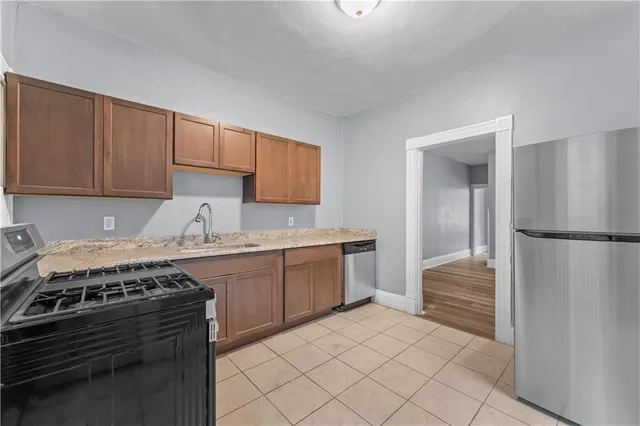 a kitchen with a stove and a refrigerator