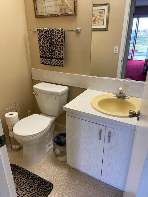 4042 Exeter C Boca Raton, FL 33434 - Photo 11 of 13 a bathroom with a sink a toilet and a mirror