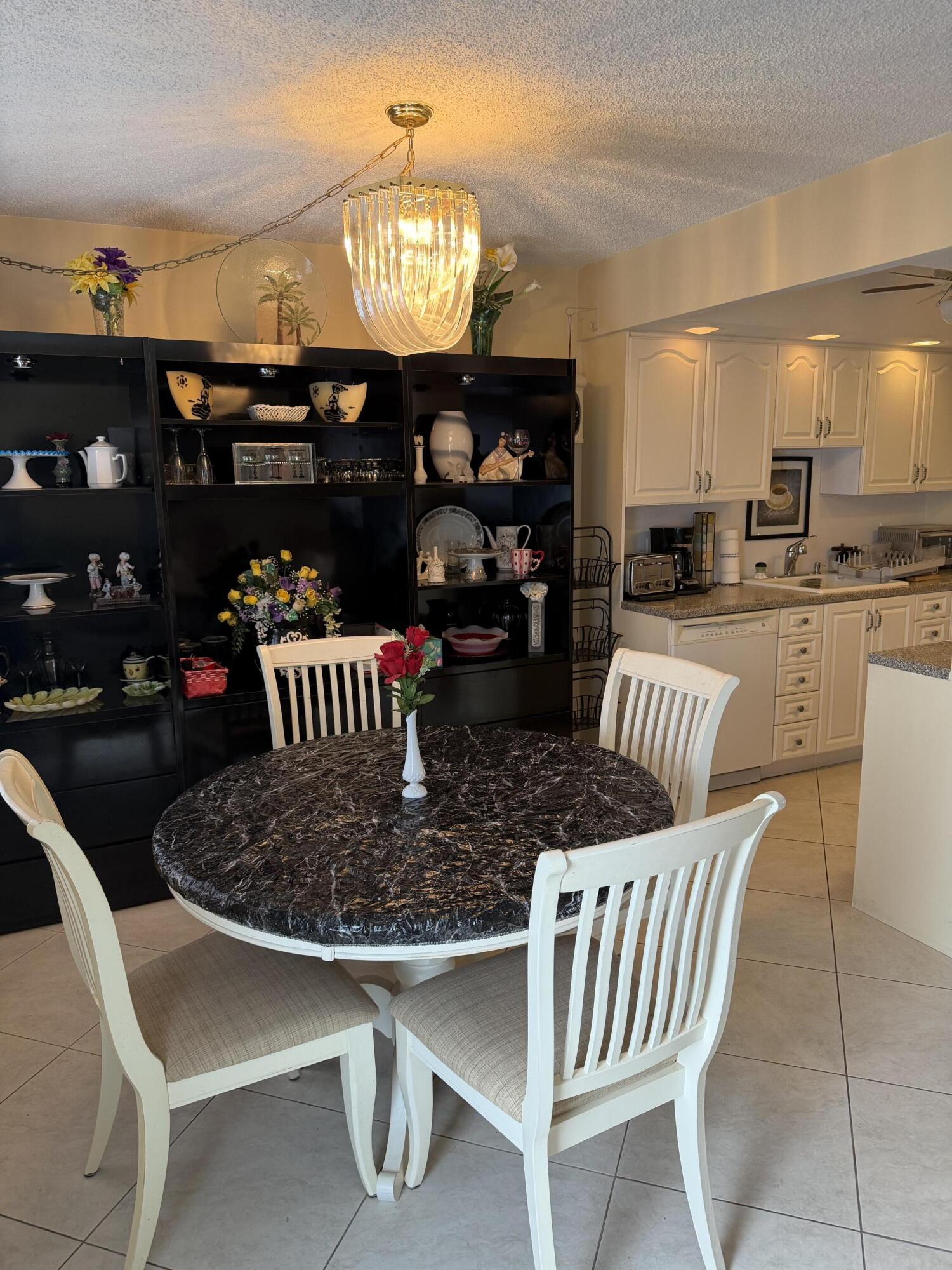 4042 Exeter C Boca Raton, FL 33434 - Photo 3 of 13 a table room with dining table and chairs