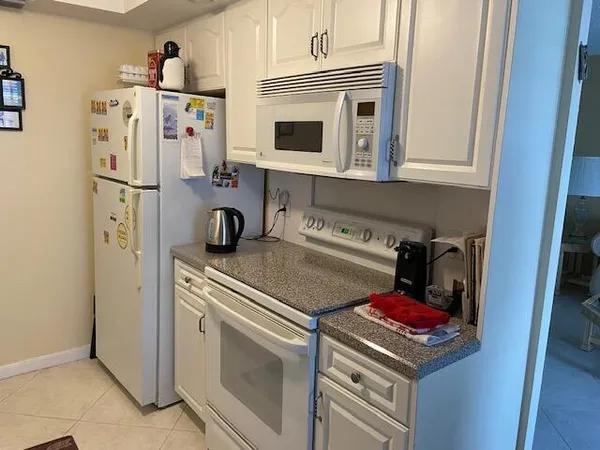 a kitchen with a refrigerator and a stove