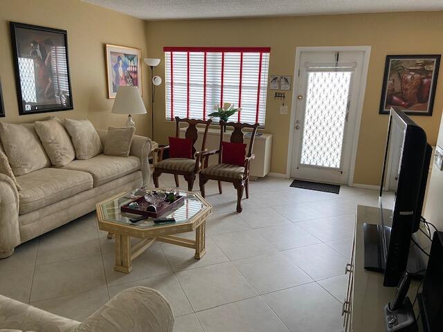 4042 Exeter C Boca Raton, FL 33434 - Photo 8 of 13 a living room with furniture and a flat screen tv