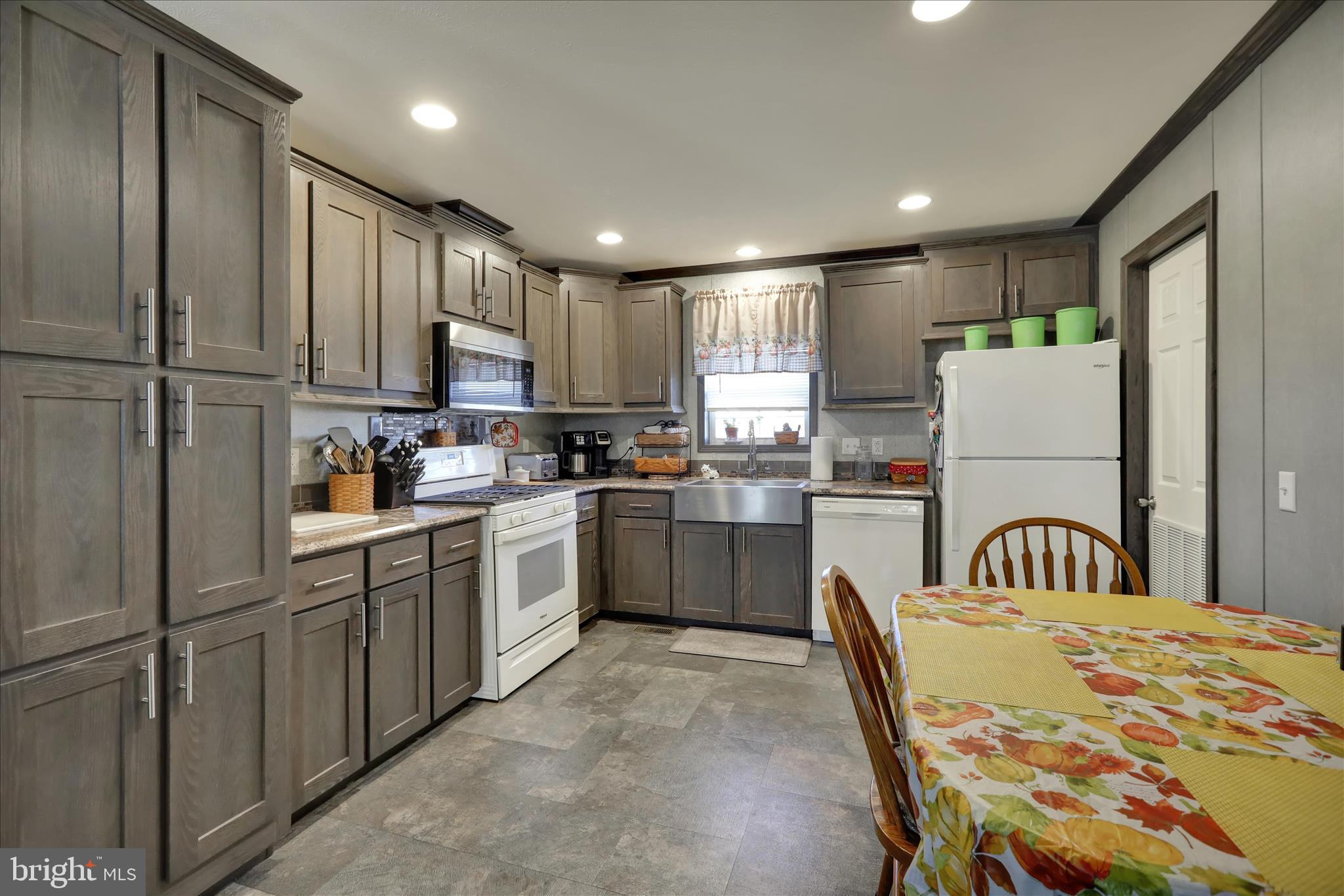 38 Keystone Road Reading, PA 19606 - Photo 12 of 22 a kitchen with stainless steel appliances granite countertop a refrigerator a stove a sink dishwasher and a refrigerator with wooden cabinets