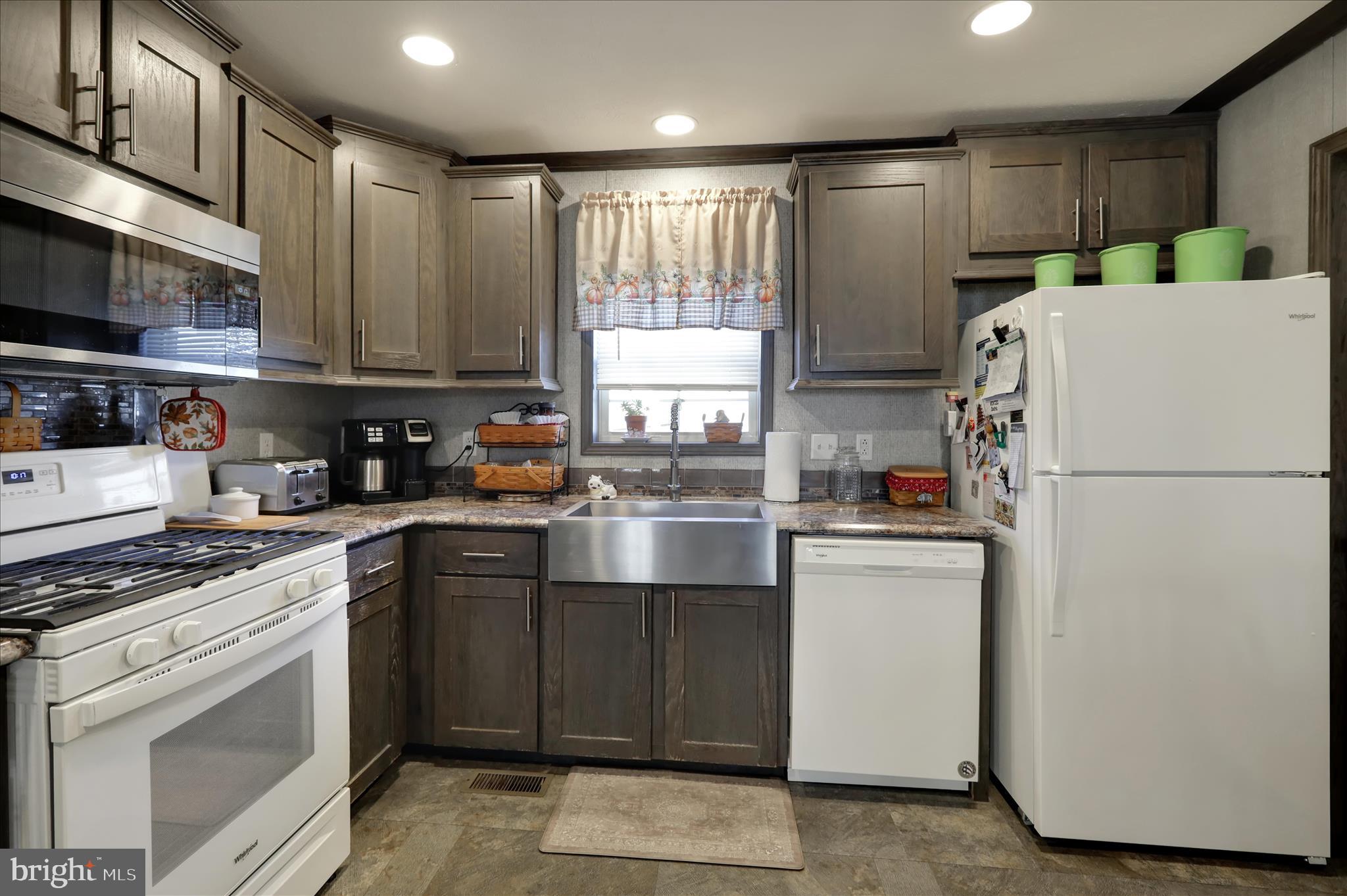 38 Keystone Road Reading, PA 19606 - Photo 13 of 22 a kitchen with a refrigerator a stove a sink and cabinets