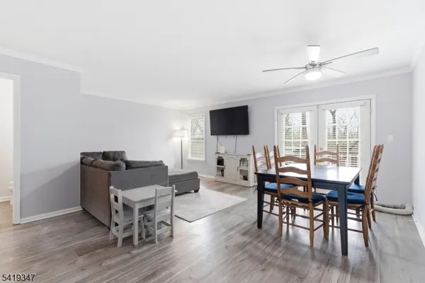 a view of a dining room with furniture window and wooden floor