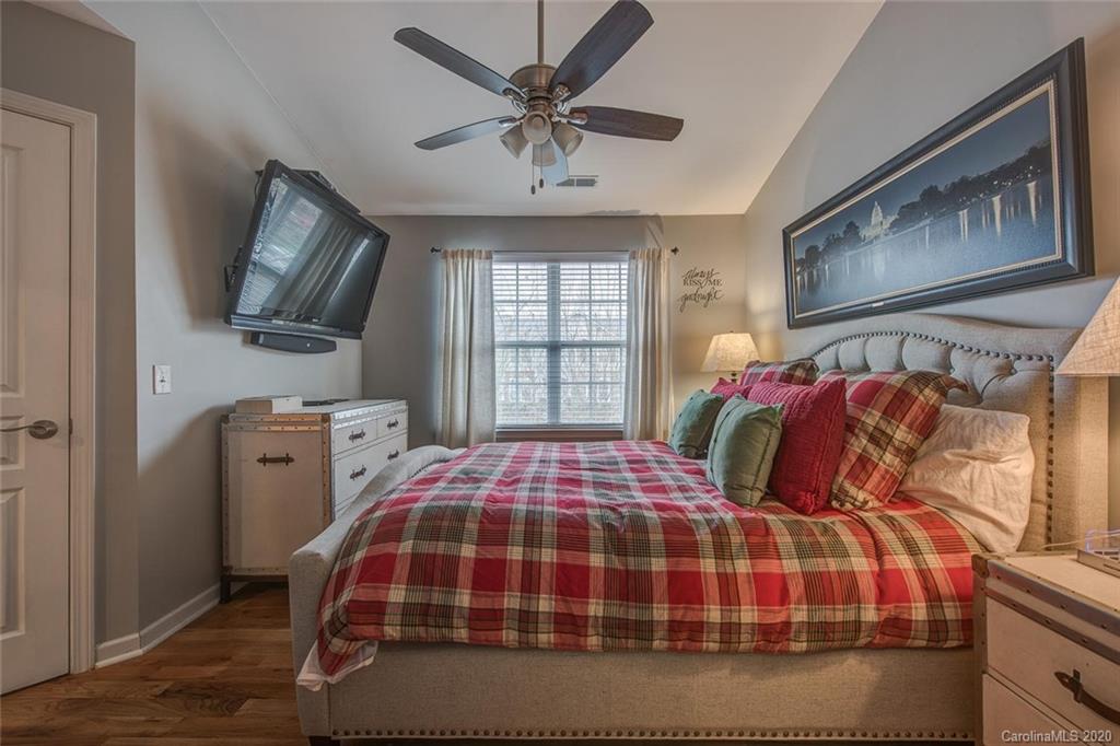 220 Falling Ridge, Unit 149 Mount Holly, NC 28012 - Photo 12 of 19 a bedroom with a bed a flat screen tv and windows