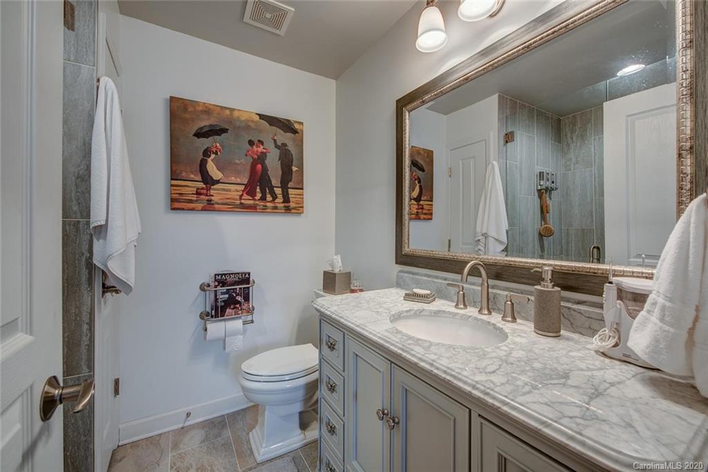 220 Falling Ridge, Unit 149 Mount Holly, NC 28012 - Photo 13 of 19 a bathroom with a granite countertop toilet sink and mirror